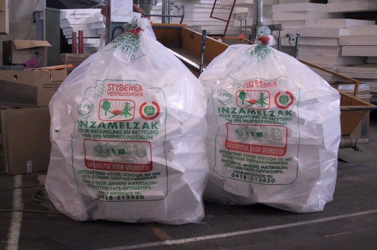 Foto van de productieomgeving met 2 inzamelzakken met daarin wit EPS restmateriaal. 